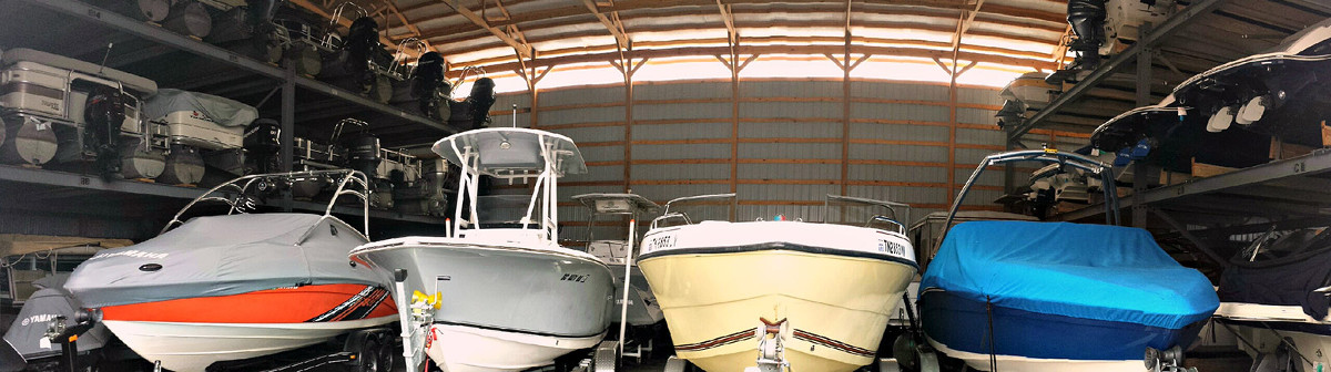 Four boats lined up inside a storage unit